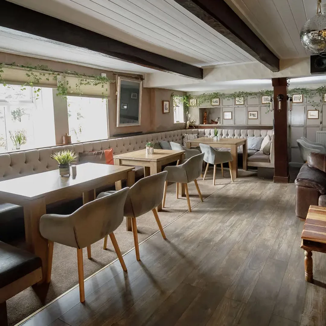 The dining room and historic picture-lined panelling inside the pub