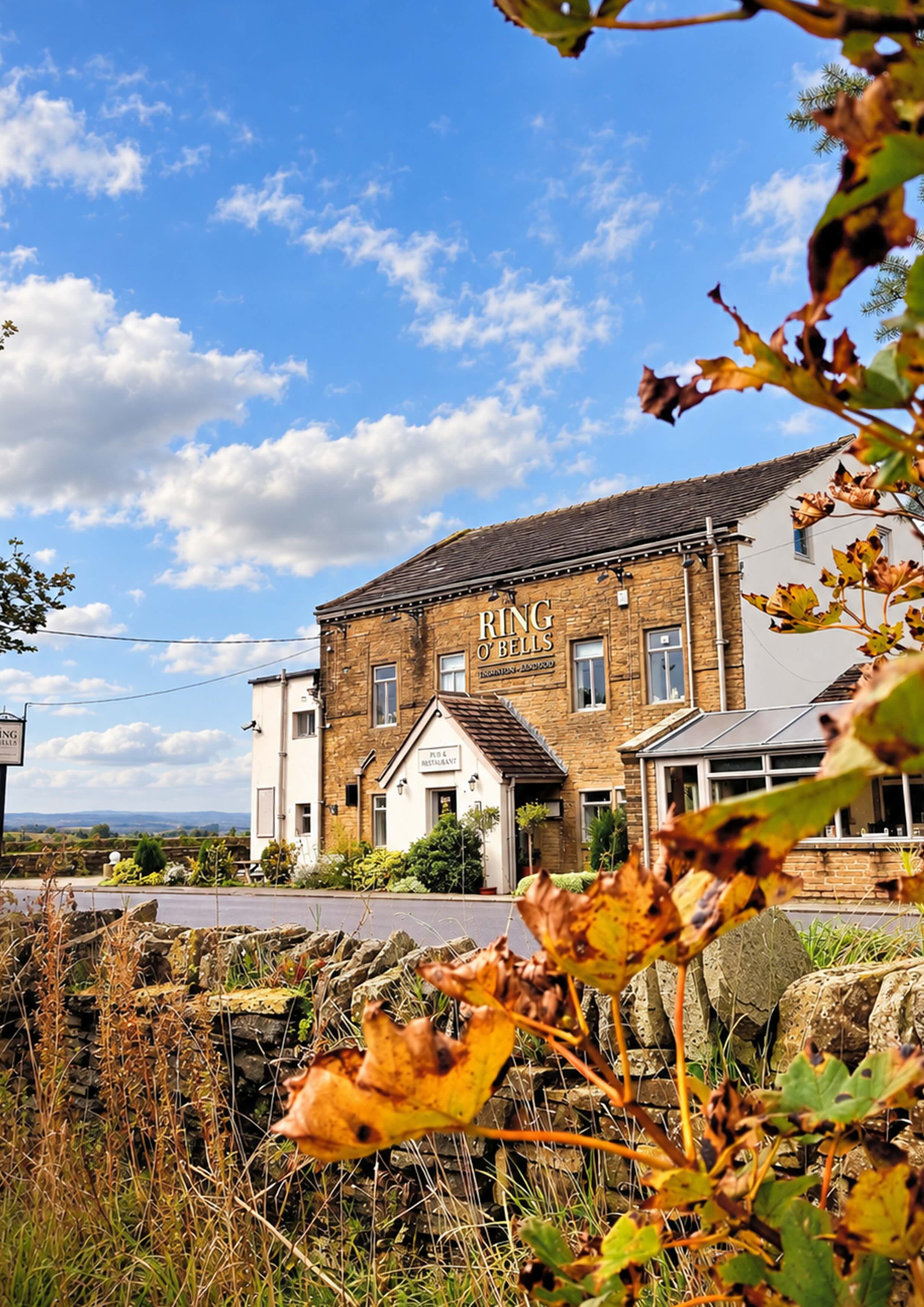 The Ring O' Bells Inn framed by autumn leaves